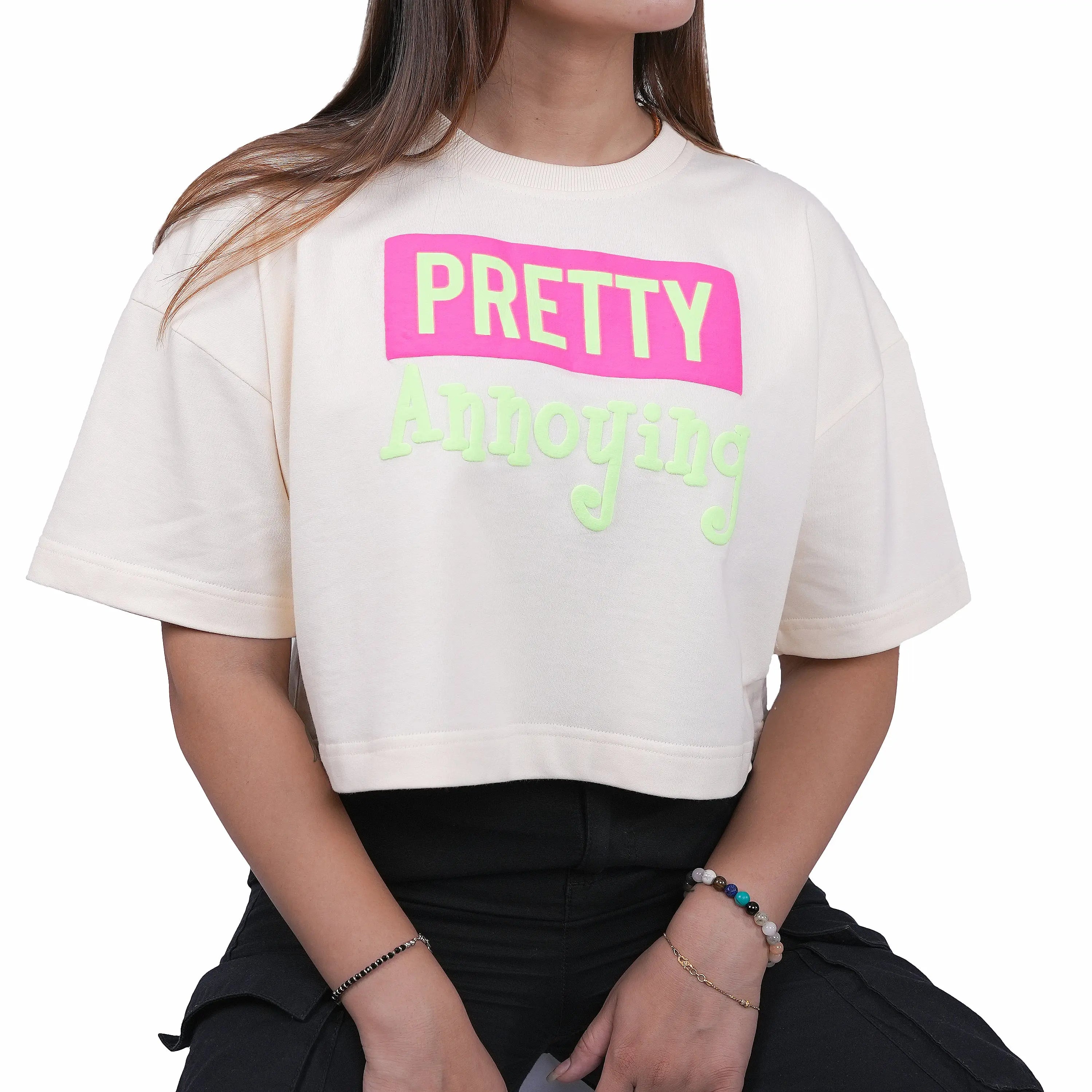 Person wearing a white t-shirt with 'PRETTY Annoying' text in pink and green.