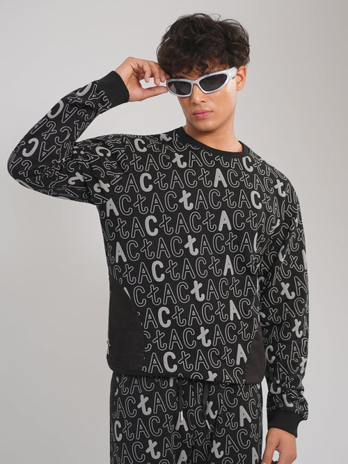 Person wearing a black sweater with white text pattern on a gray background