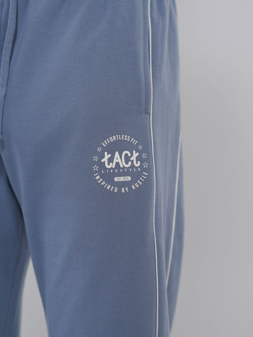 Blue pants with a white logo on a gray background