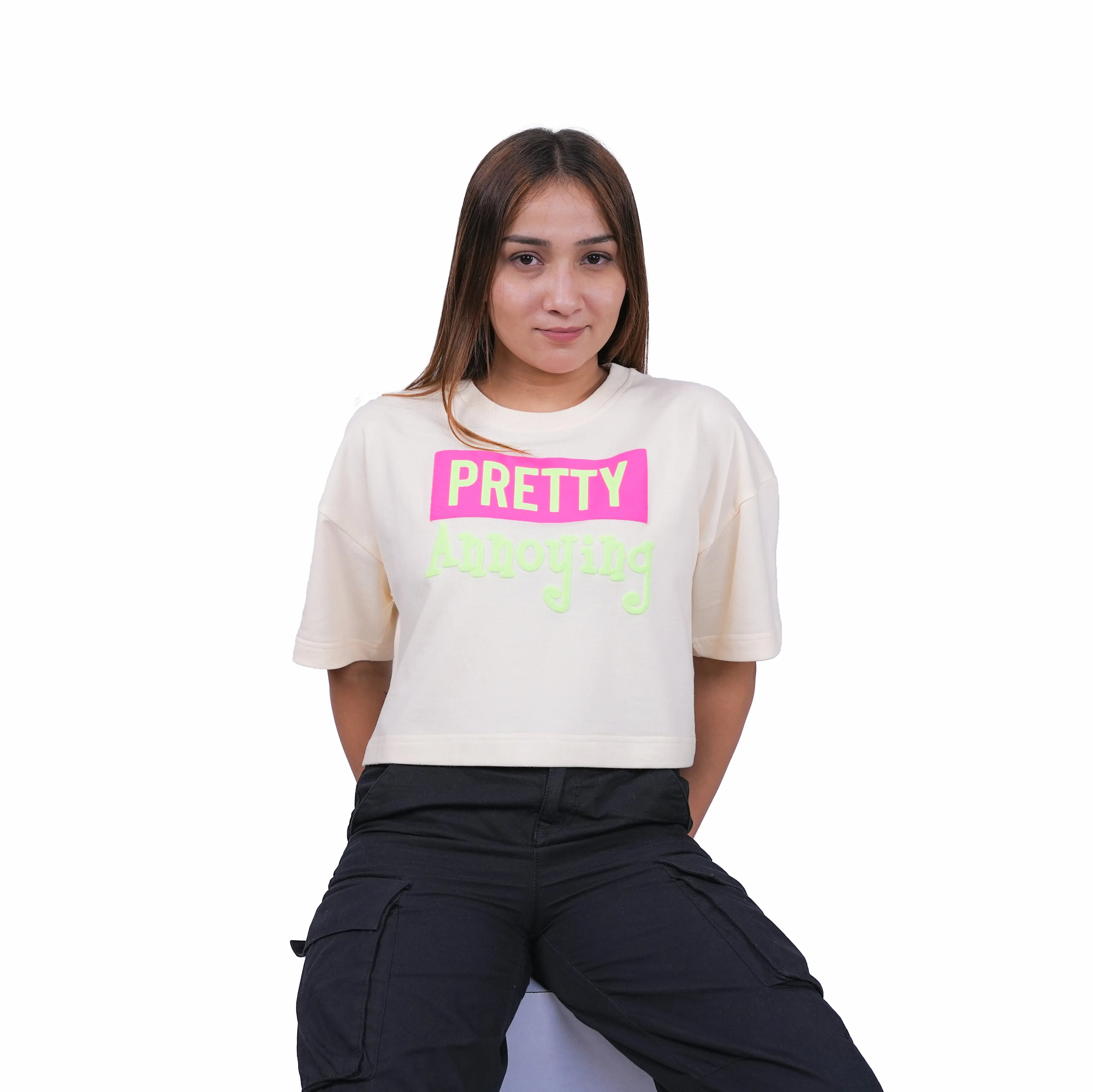 Person wearing a white t-shirt with colorful text on a white background